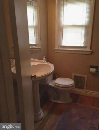 a bathroom with a toilet a sink and a window
