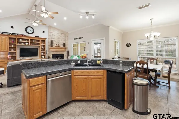 a kitchen with granite countertop a stove a sink and a refrigerator
