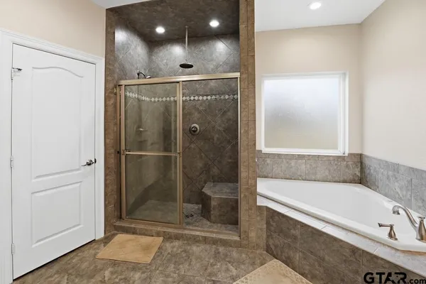 a bathroom with a bathtub and a shower