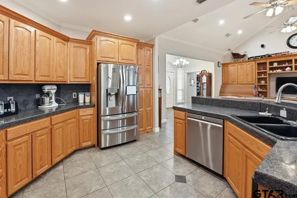 a kitchen with stainless steel appliances granite countertop a sink and cabinets