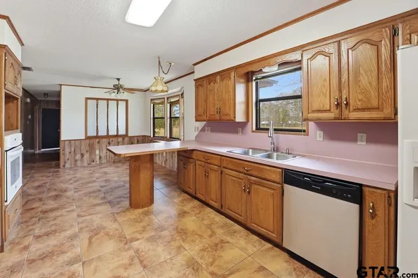 a kitchen with granite countertop a sink and cabinets