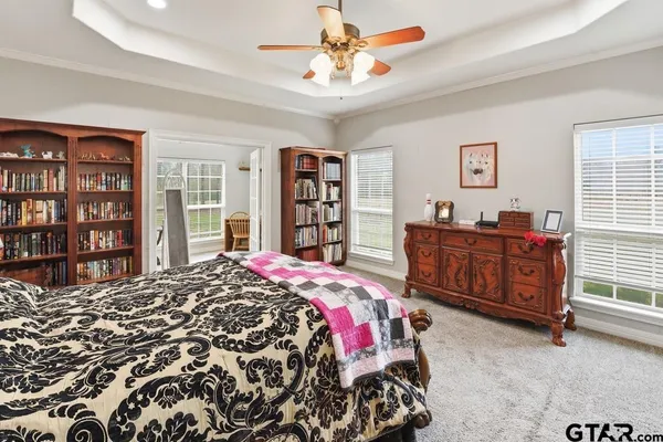 a bedroom with a bed a dresser and a book shelf