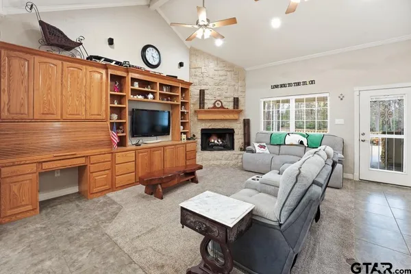 a living room with furniture a fireplace and a flat screen tv