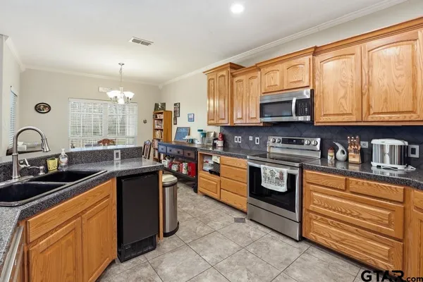 a kitchen with stainless steel appliances granite countertop a stove sink and microwave