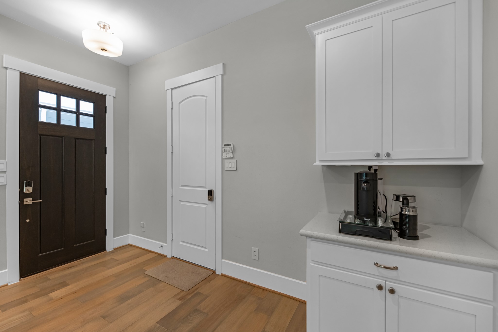 11 Thorpe Lane Spring, TX 77389 - Photo 12 of 34 Chic entry space includes a stylish coffee bar, blending functionality with a warm, inviting touch.