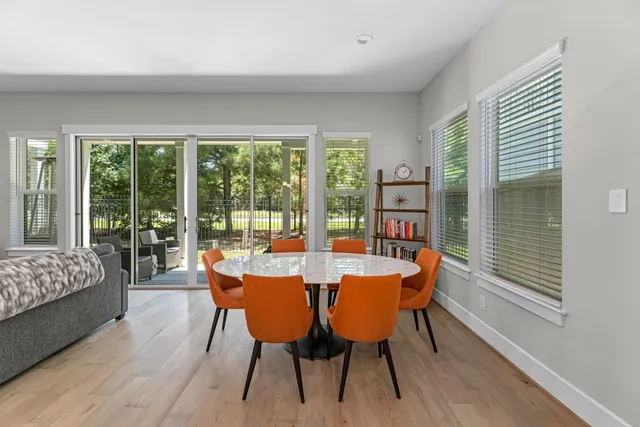 a dining room with furniture window and wooden floor