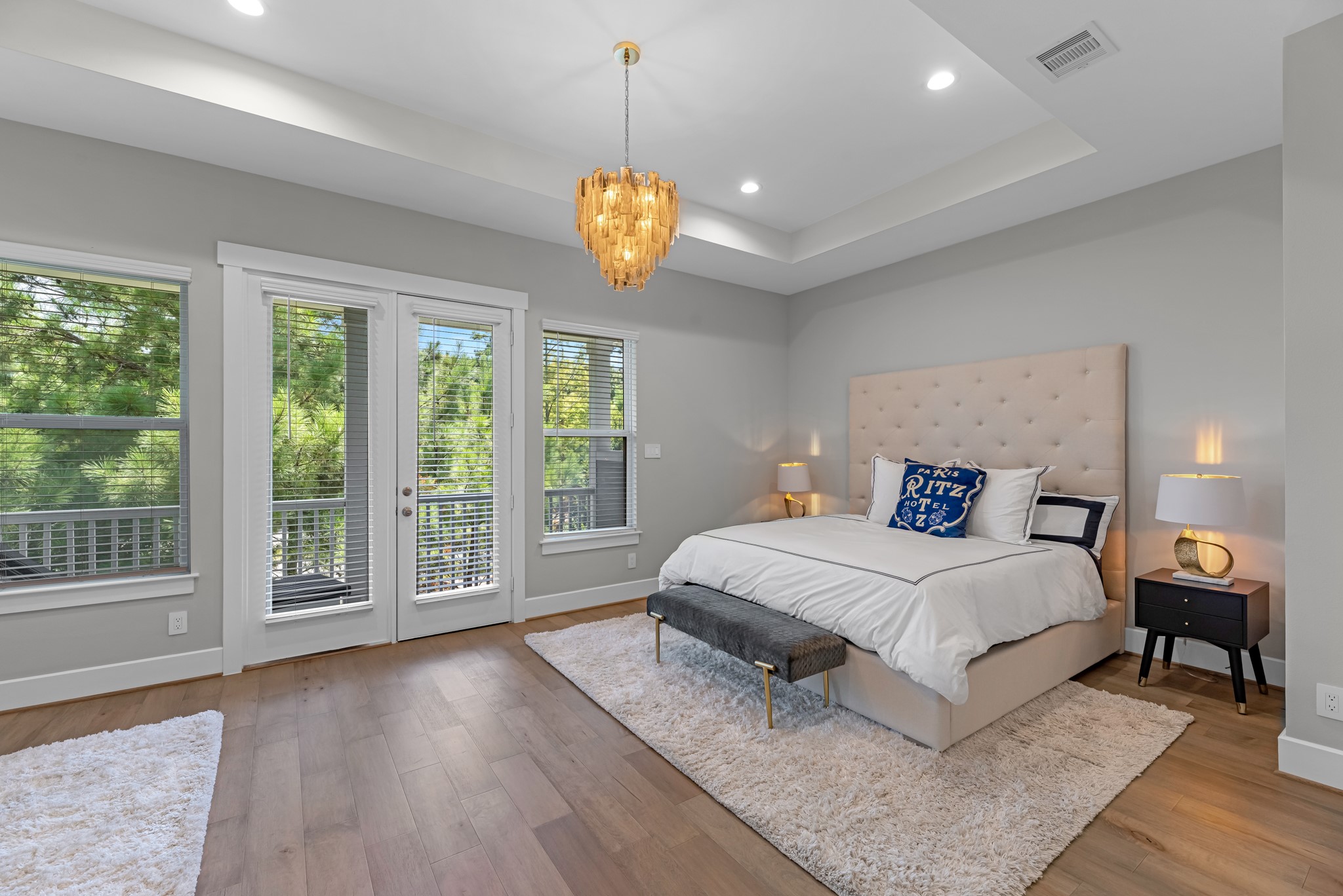 11 Thorpe Lane Spring, TX 77389 - Photo 22 of 34 The primary bedroom is generously sized, creating a tranquil and spacious retreat that offers ample room for relaxation. Featuring sleek floors, high ceilings, fresh paint, and large windows that lets in natural lighting throughout the day.