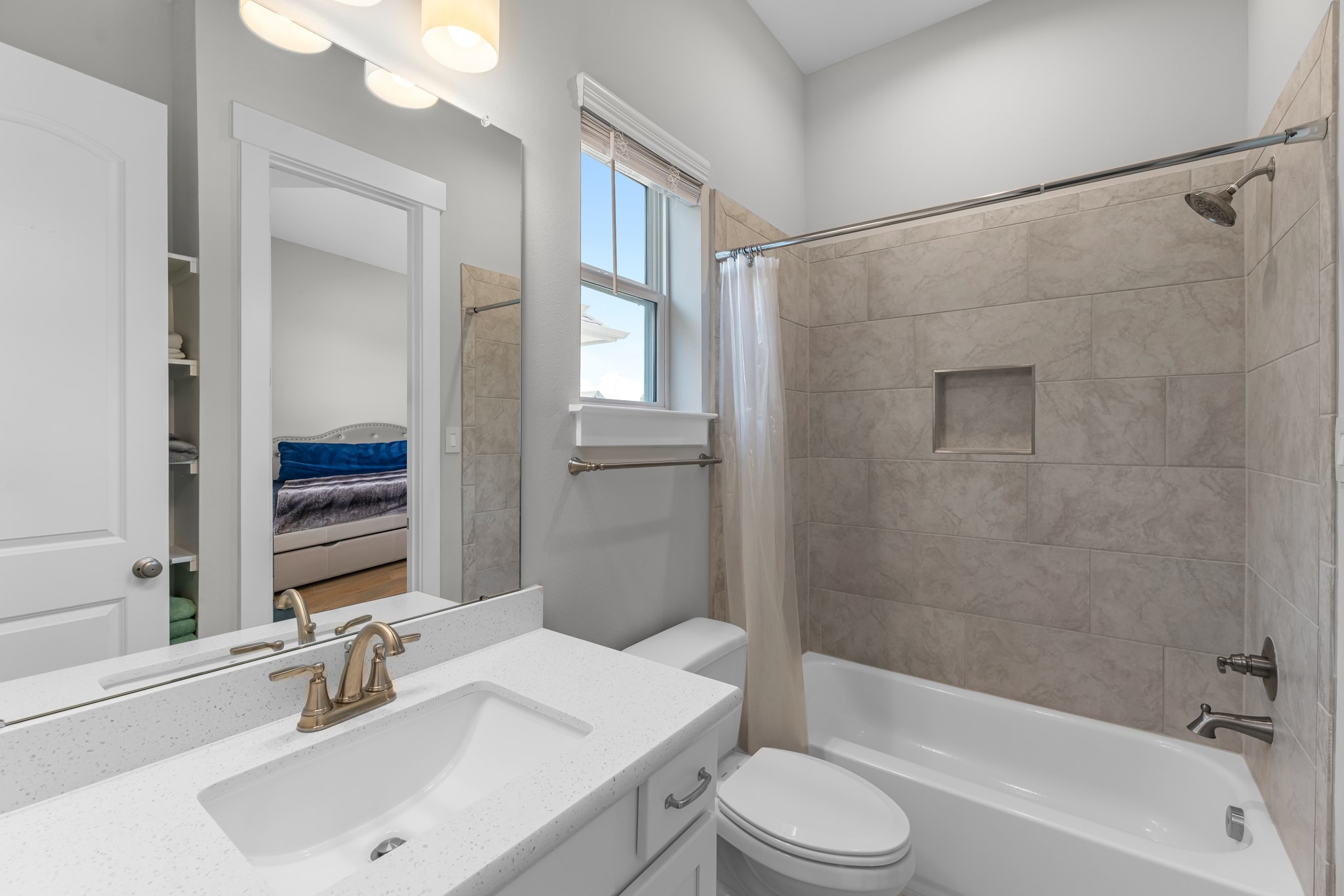 11 Thorpe Lane Spring, TX 77389 - Photo 31 of 34 The secondary bath features tile flooring, white cabinetry and light countertops and a shower/tub combo. Perfect for accommodating any visiting family and friends.