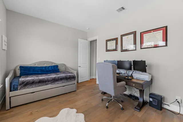 a livingroom with workspace and a couch