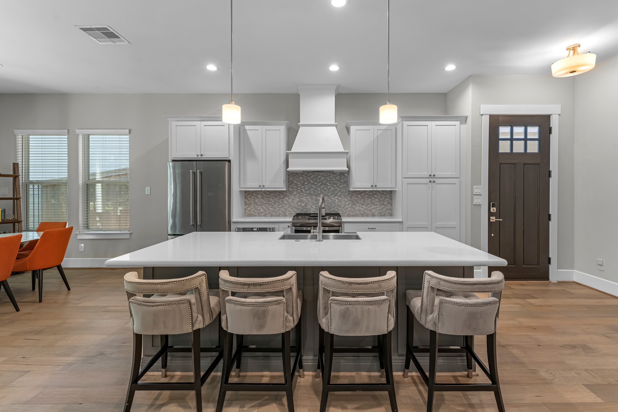 11 Thorpe Lane Spring, TX 77389 - Photo 5 of 34 This light and bright kitchen features a large quartz island, white cabinets, a large sink overlooking your family room, recessed lighting, and beautiful backsplash.