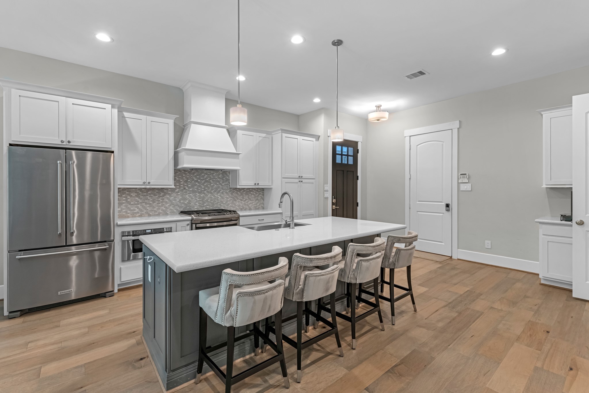 11 Thorpe Lane Spring, TX 77389 - Photo 7 of 34 Additional view of the kitchen showing the front entrance and garage entrance.