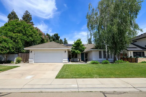 a front view of house with yard and green space