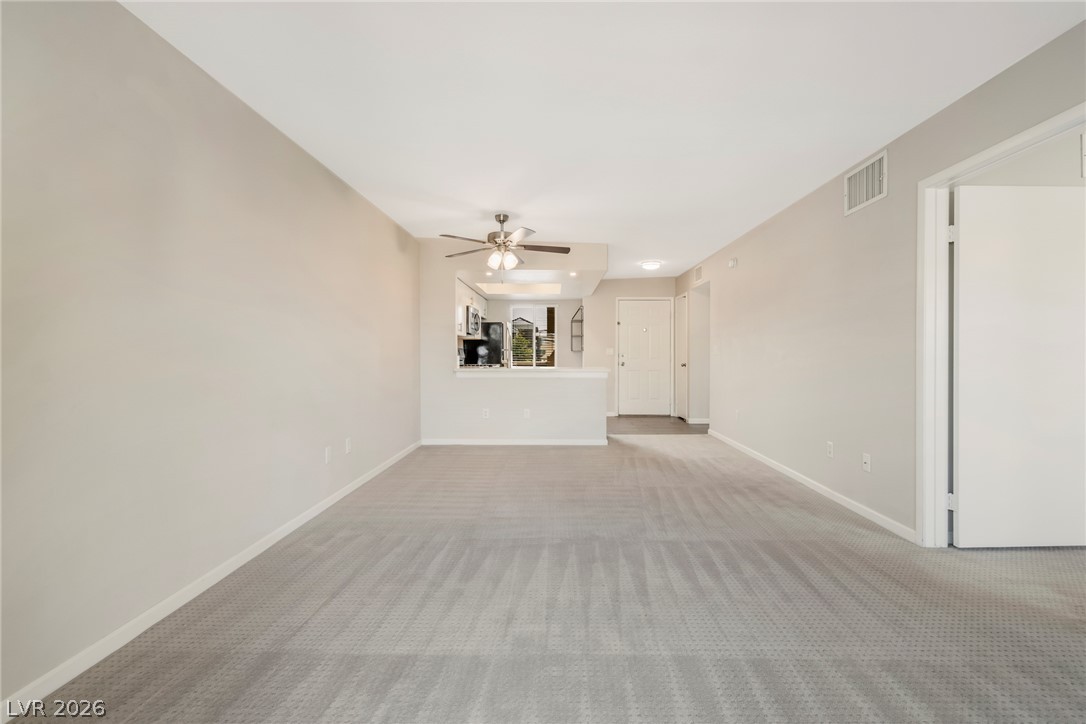 8070 West Russell Road, Unit 2006 Las Vegas, NV 89113 - Photo 15 of 24 A spacious living area with new carpeting offers an open concept to the kitchen, perfect for entertaining.