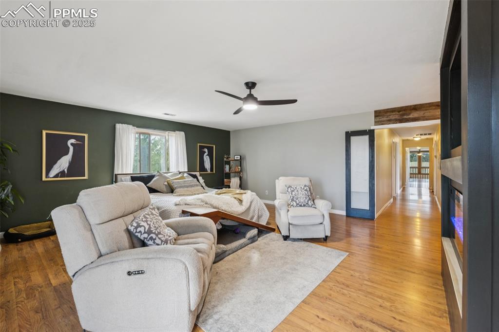 17940 Appaloosa Road Monument, CO 80132 - Photo 16 of 44 a living room with furniture and a chandelier