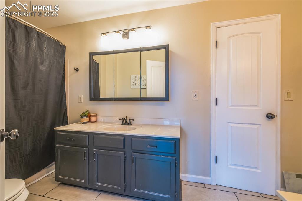 17940 Appaloosa Road Monument, CO 80132 - Photo 21 of 44 a bathroom with a double vanity sink mirror and toilet