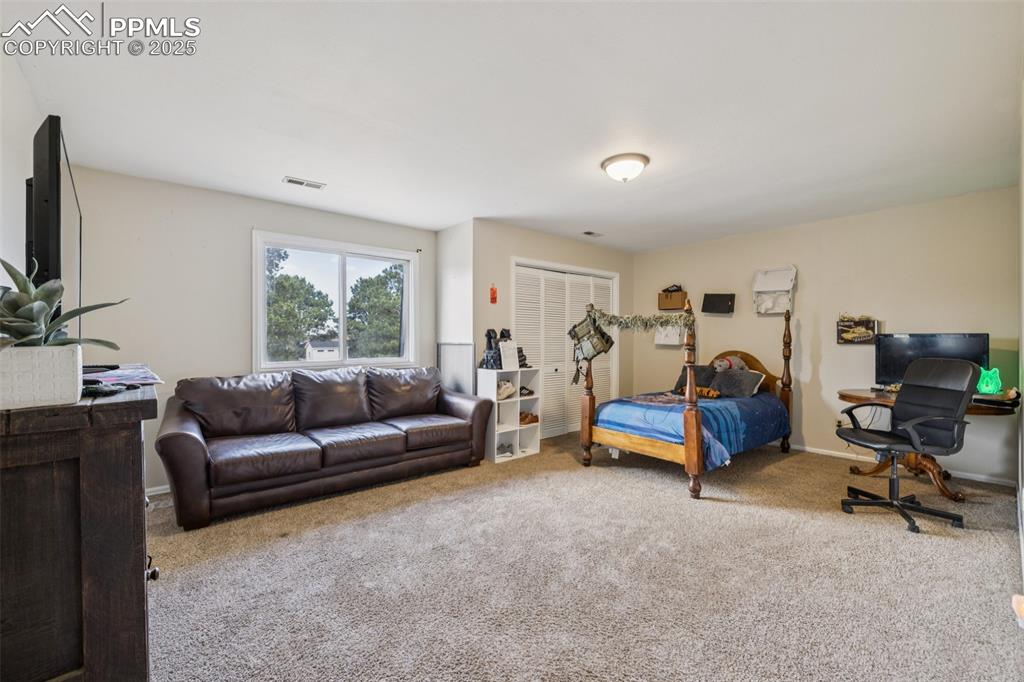 17940 Appaloosa Road Monument, CO 80132 - Photo 22 of 44 a living room with furniture and a flat screen tv