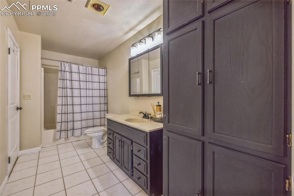 17940 Appaloosa Road Monument, CO 80132 - Photo 24 of 44 a bathroom with a sink a toilet and mirror