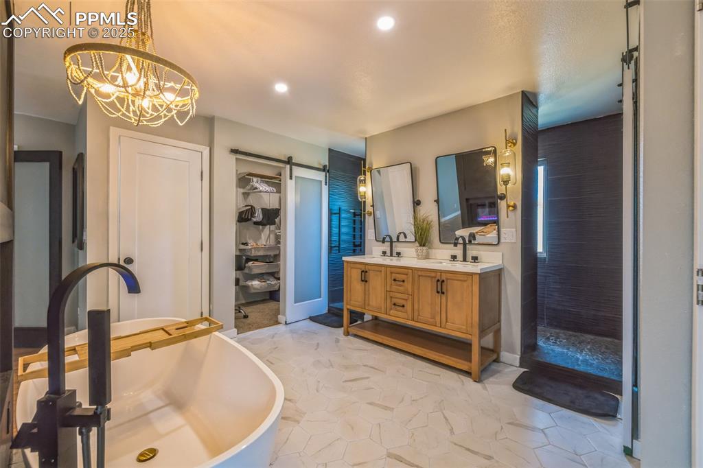 17940 Appaloosa Road Monument, CO 80132 - Photo 3 of 44 a bathroom with a tub sink and mirror