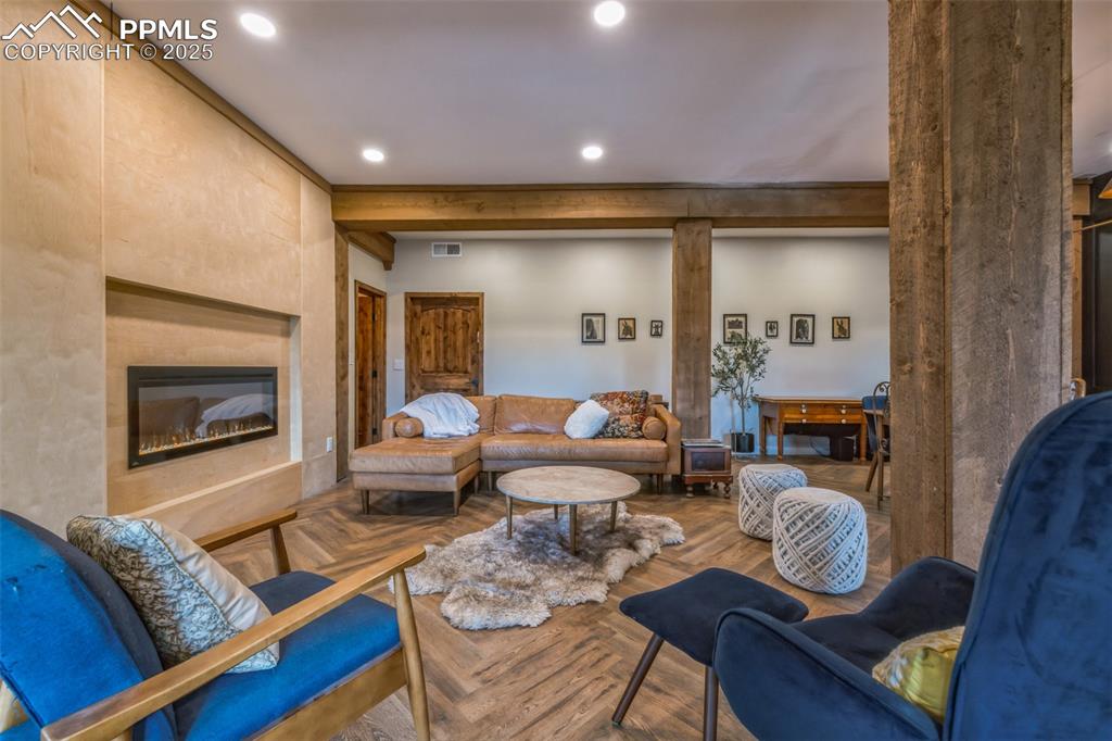 17940 Appaloosa Road Monument, CO 80132 - Photo 8 of 44 a living room with furniture and a wooden floor