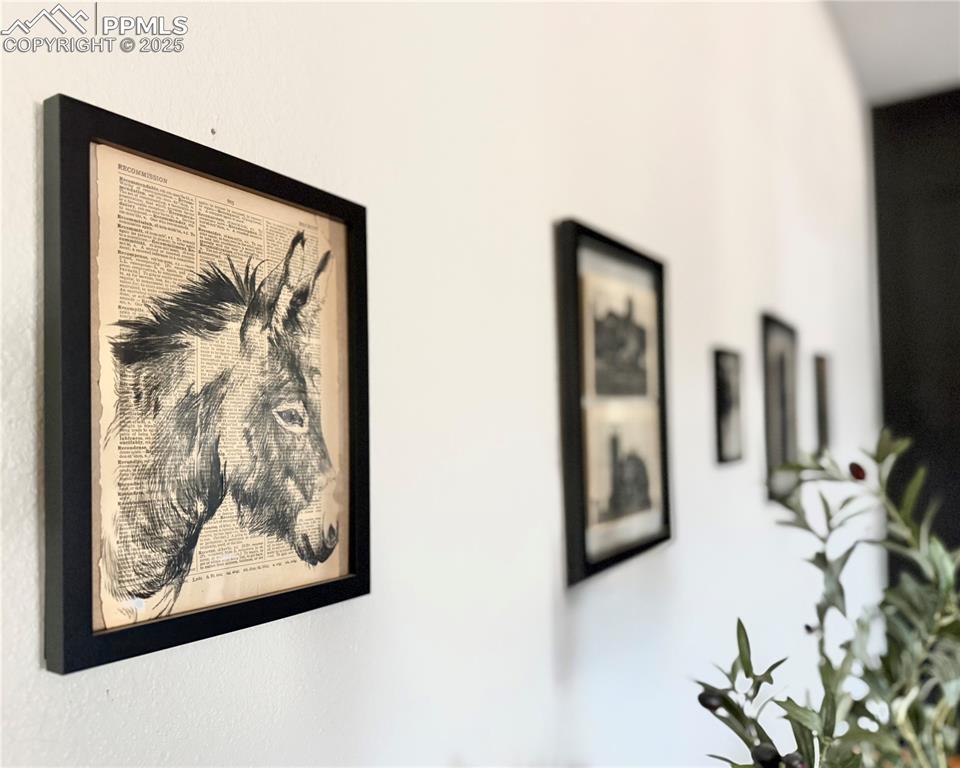 17940 Appaloosa Road Monument, CO 80132 - Photo 10 of 44 a view of a hallway with two painting on the wall and a large mirror