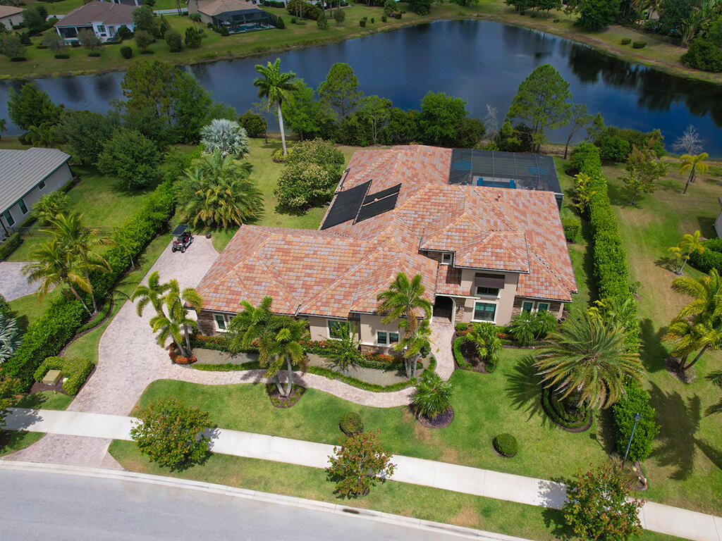 an aerial view of a house with garden space and lake view