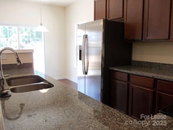 a kitchen with a refrigerator and a sink