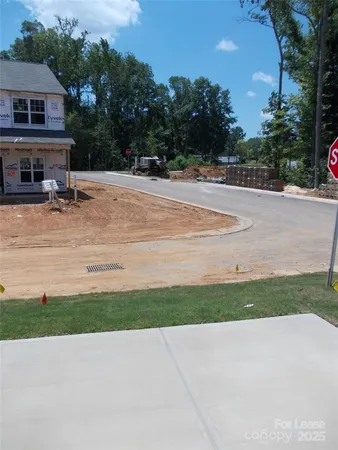 a view of house with outdoor space and parking