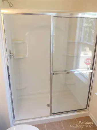 a bathroom with a glass shower door