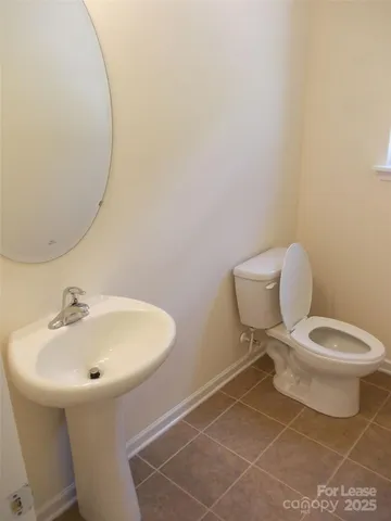a white toilet sitting next to a bathroom sink