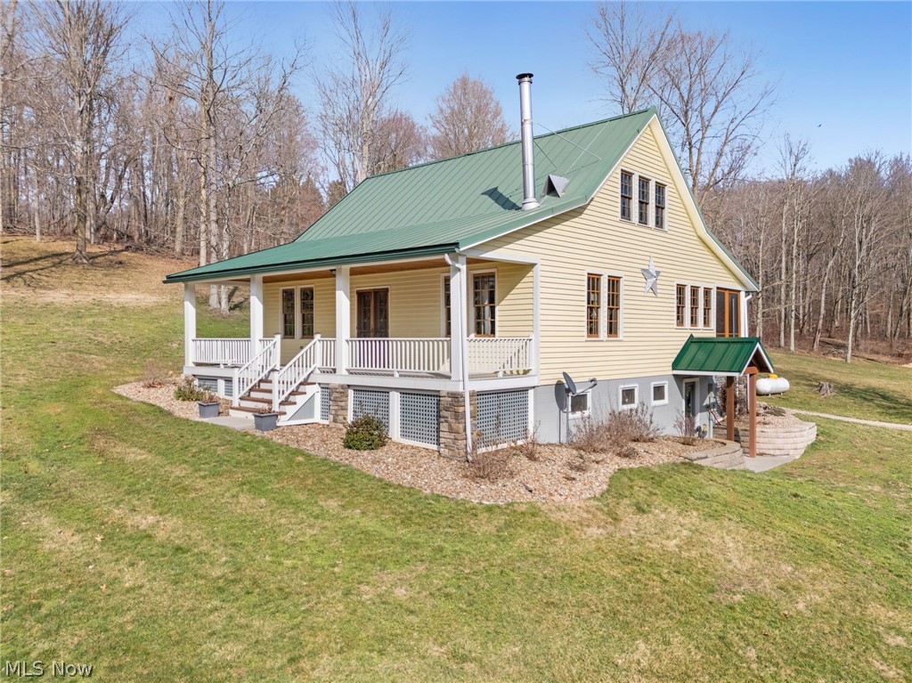 2210 Scroll Road Southwest Carrollton, OH 44615 - Photo 3 of 48 Back of property with a porch, a metal roof, and a lawn