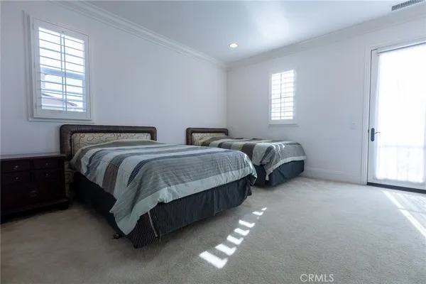 a spacious bedroom with two beds and a window