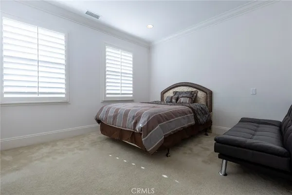 a bedroom with a bed couch and window