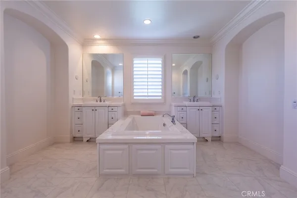 a bathroom with a sink a vanity and tub