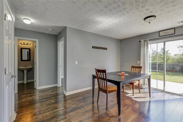 a view of a workspace with furniture and window