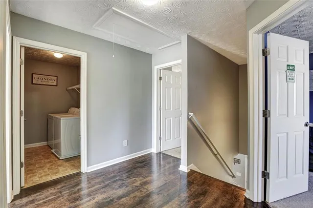 a view of a hallway with wooden floor and entryway