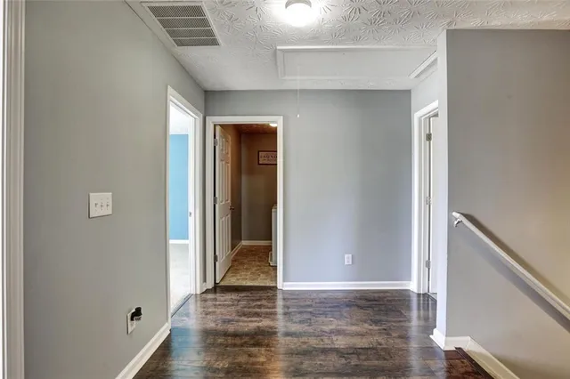a view of a hallway with wooden floor