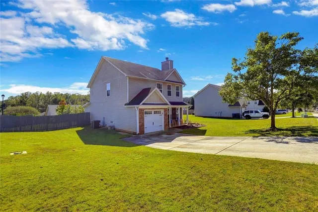 a view of a house with swimming pool and a yard