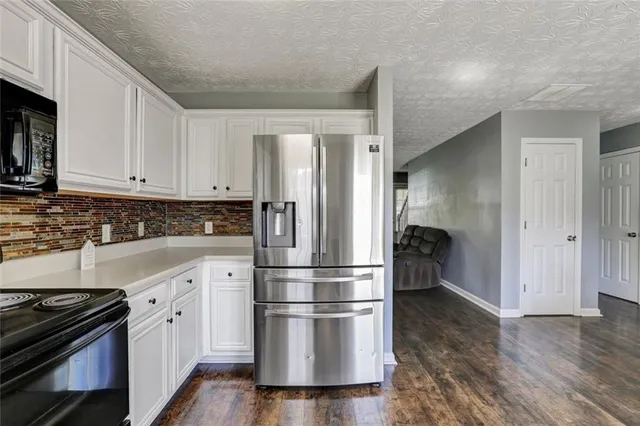 a kitchen with wooden floors and appliances