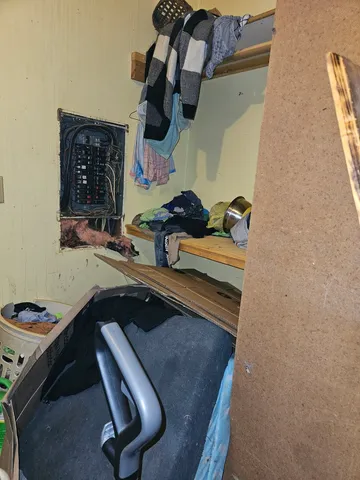 a view of a room with wooden floor and a ceiling fan