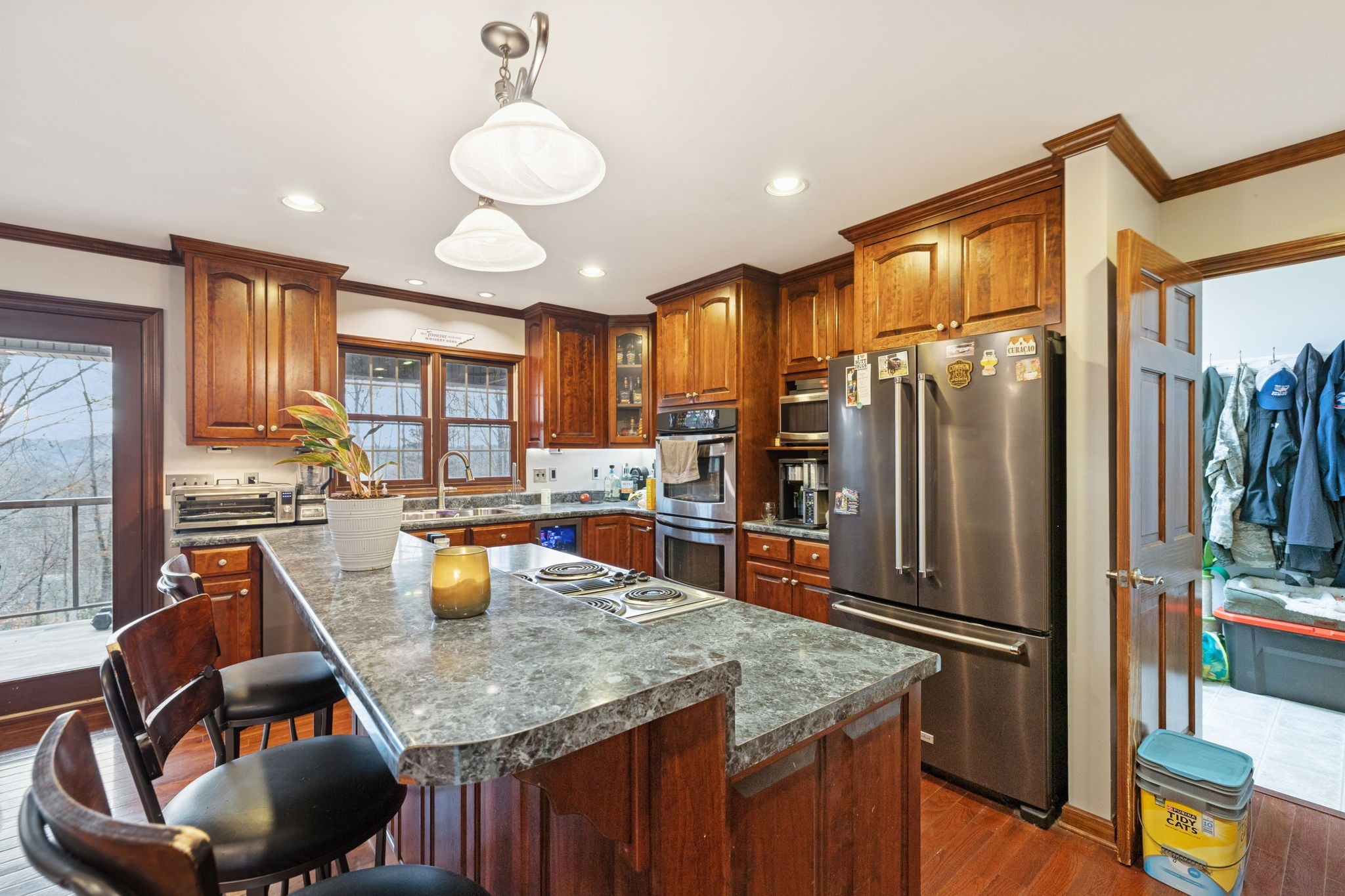 516 Rhotons Chapel Road Manchester, TN 37355 - Photo 18 of 52 a kitchen with stainless steel appliances granite countertop a refrigerator a oven a sink a dining table and chairs