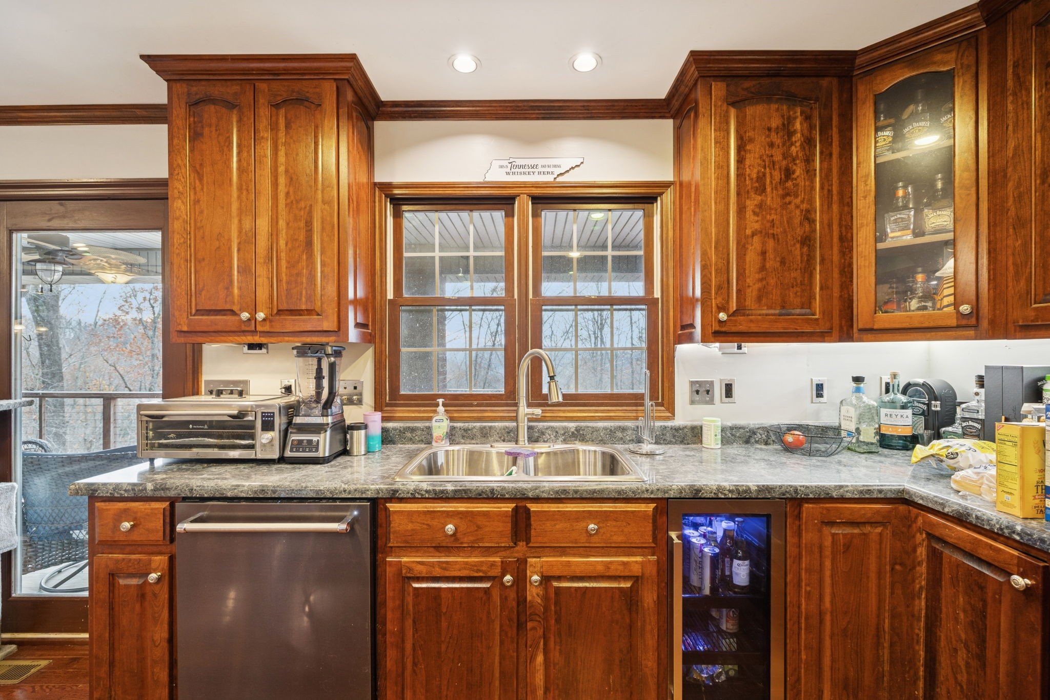 516 Rhotons Chapel Road Manchester, TN 37355 - Photo 19 of 52 a kitchen with stainless steel appliances granite countertop wooden cabinets a sink and a window