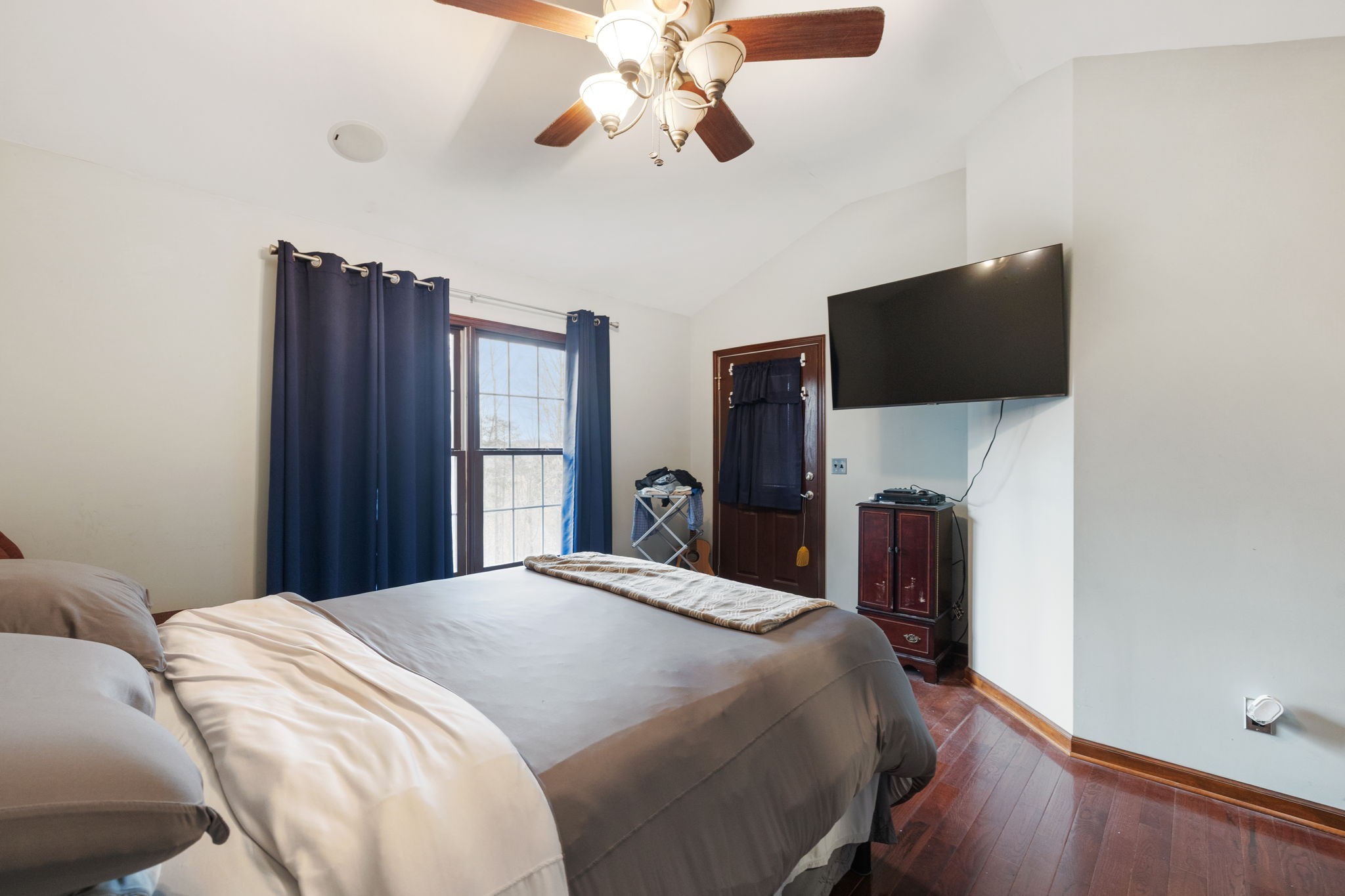 516 Rhotons Chapel Road Manchester, TN 37355 - Photo 22 of 52 a bedroom with a bed and a flat tv screen on a dresser