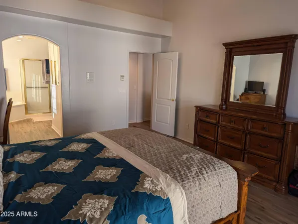 a bedroom with a bed and a dresser in it