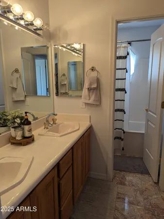 a bathroom with a sink a vanity and a mirror