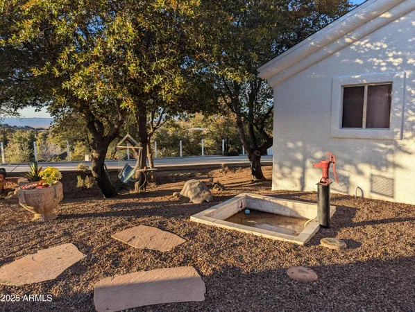 a view of a house with backyard and sitting area