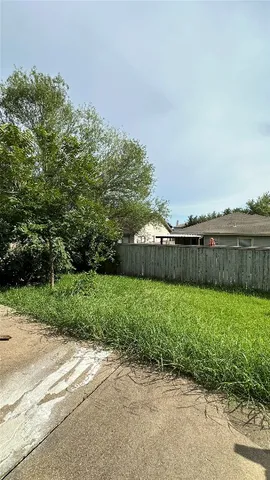 a kitchen with granite countertop a refrigerator and a stove top oven