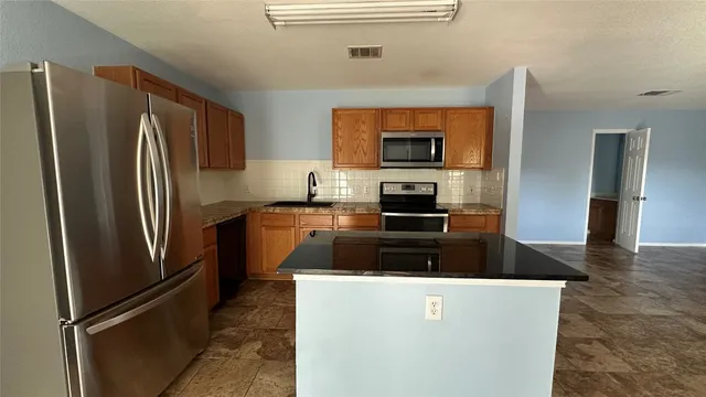 a kitchen with a stove and a microwave
