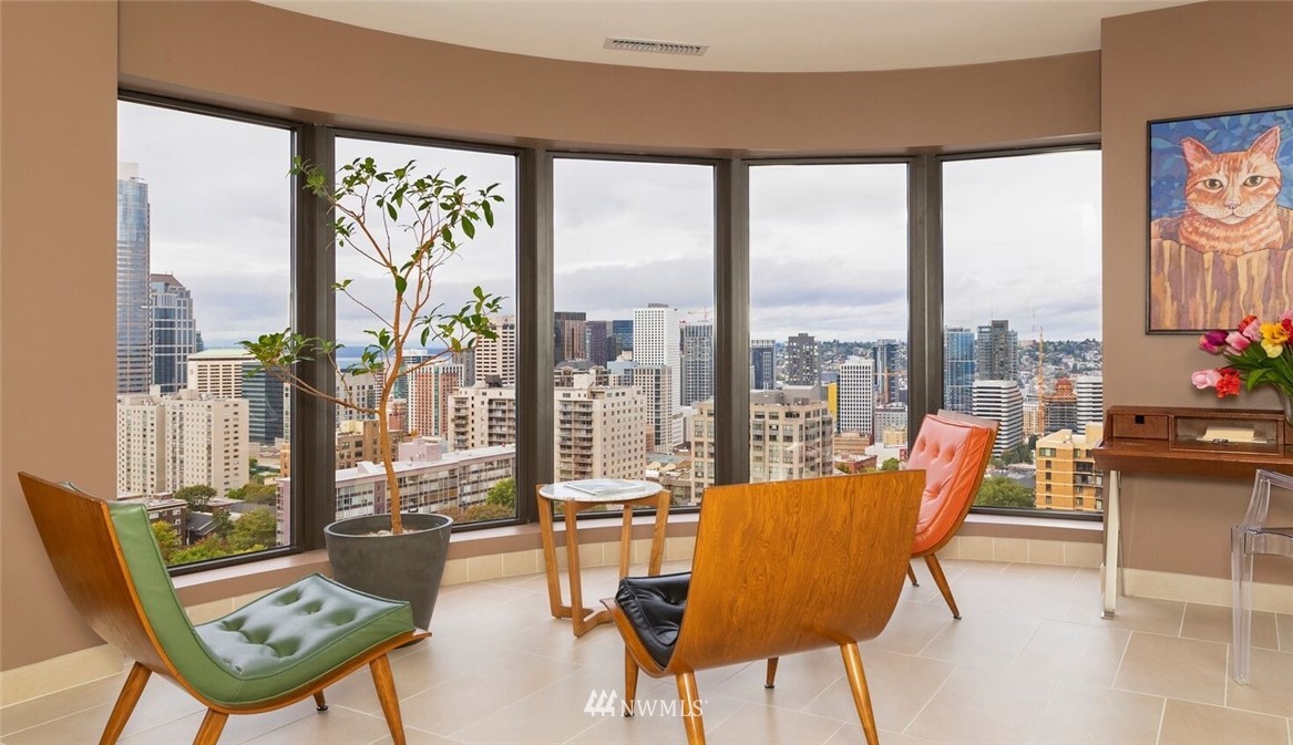 1301 Spring Street, Unit 18J Seattle, WA 98104 - Photo 2 of 25 a living room with furniture and a floor to ceiling window