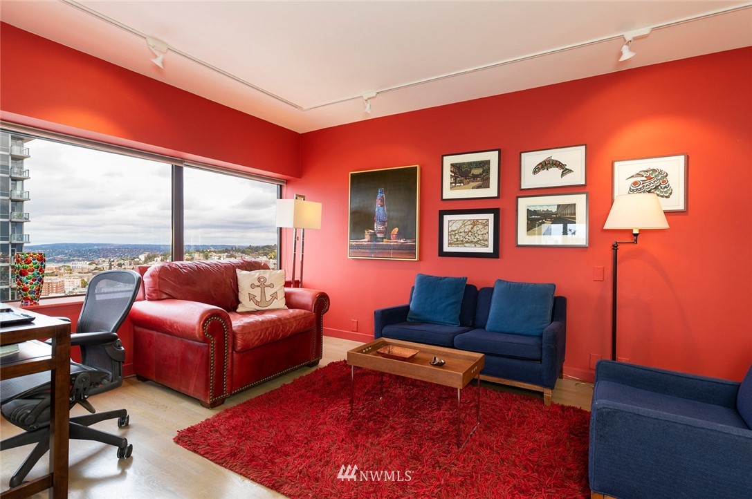 1301 Spring Street, Unit 18J Seattle, WA 98104 - Photo 13 of 25 a living room with furniture a rug and a floor to ceiling window
