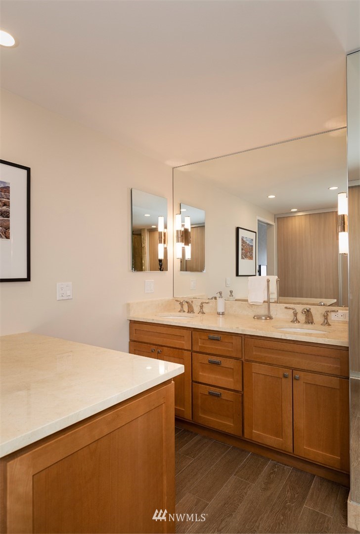 1301 Spring Street, Unit 18J Seattle, WA 98104 - Photo 16 of 25 a large bathroom with a sink and a mirror
